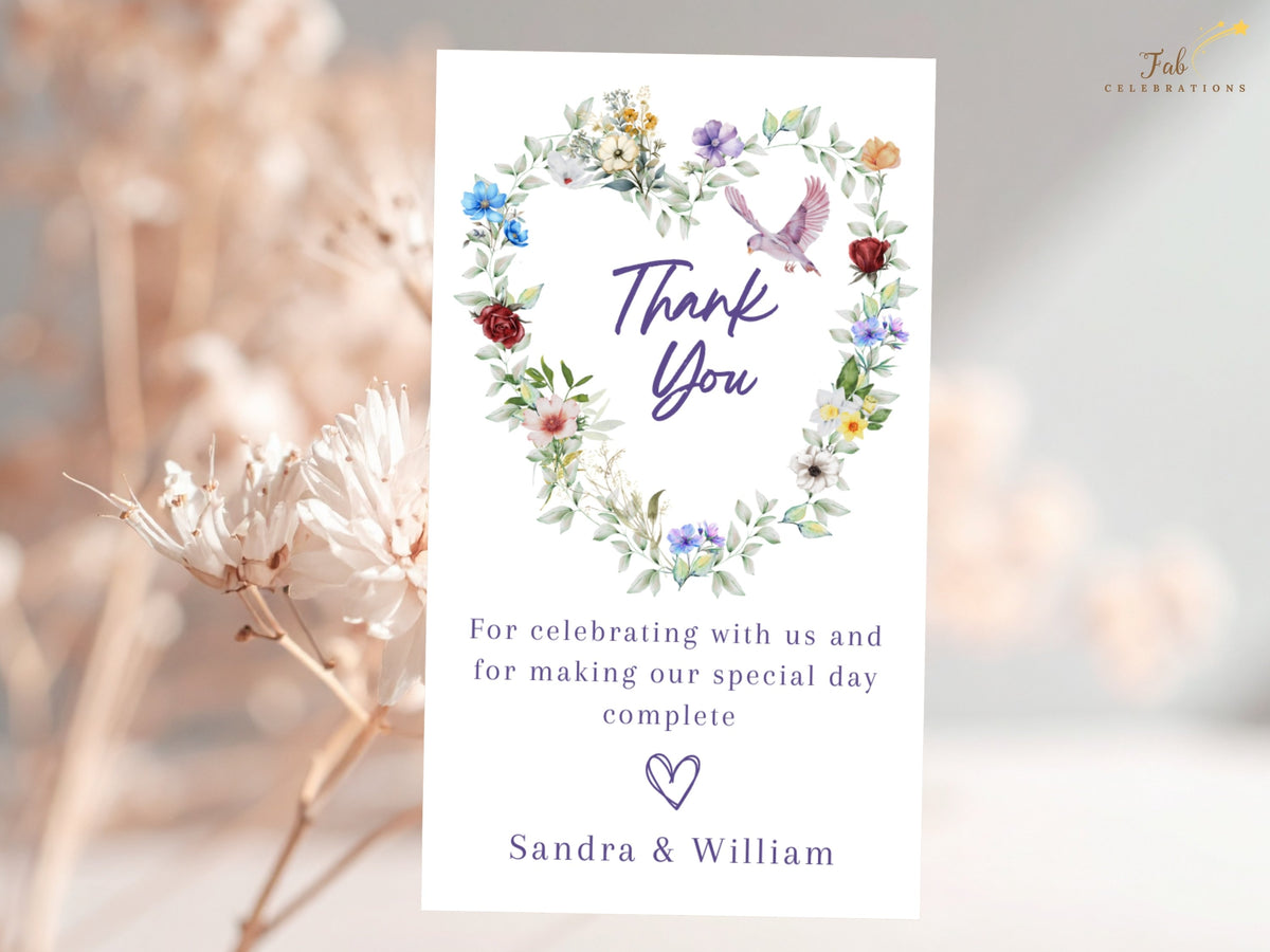 Garden gratitude card featuring a watercolor-inspired floral heart with delicate multicolored blossoms, soft greenery and a graceful dove above a warm message of thanks from the newlyweds.