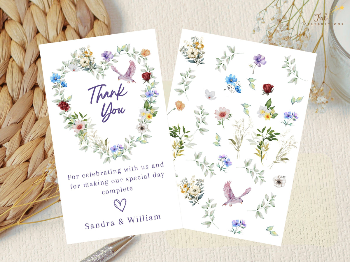 Wedding thank you card displayed with coordinating watercolor-inspired floral elements, including colorful blossoms, leafy greenery and graceful dove illustrations from the collection.