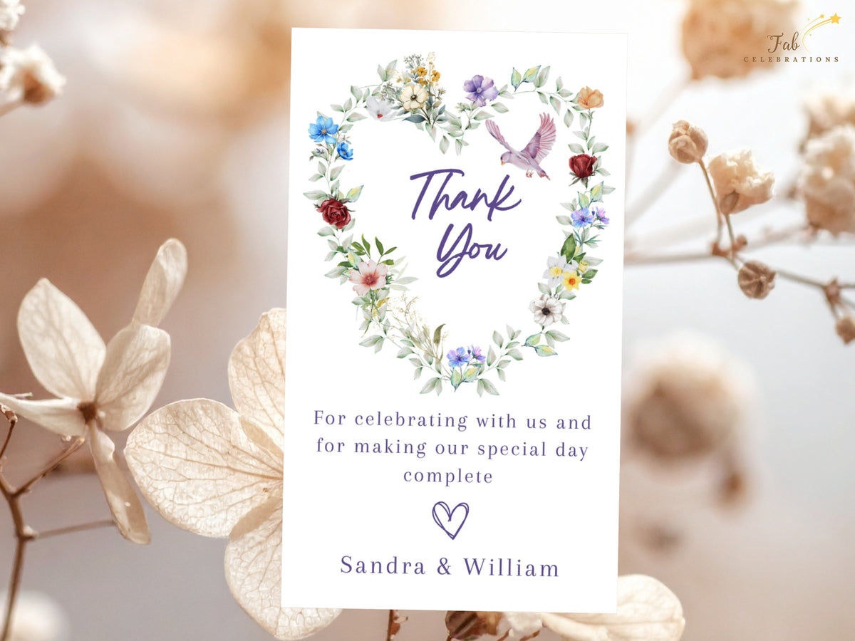 Watercolor-inspired wedding thank you card featuring a romantic heart of colorful flowers and soft greenery with a graceful dove above a warm gratitude message from the newlyweds.