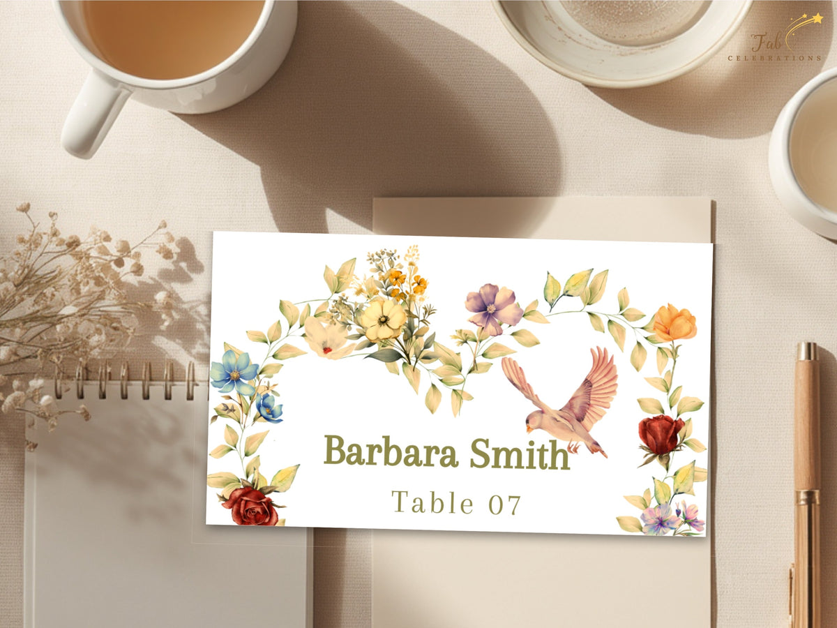 Romantic wedding place card displayed beside a warm cup of coffee, with Barbara Smith and Table 07 surrounded by delicate watercolor-inspired yellow blooms, blush flowers, and a soft dove.