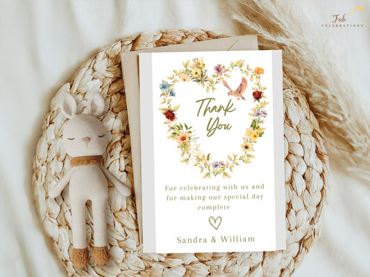 Romantic Wedding Thank You Card featuring a watercolor-inspired floral heart wreath, graceful dove illustration, soft beige background and editable Canva design for elegant wedding stationery.