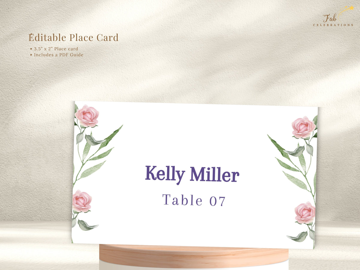 Editable wedding place card shown with watercolor-inspired pink rose accents and graceful green leaves, personalized with a guest name and table number in refined purple lettering.