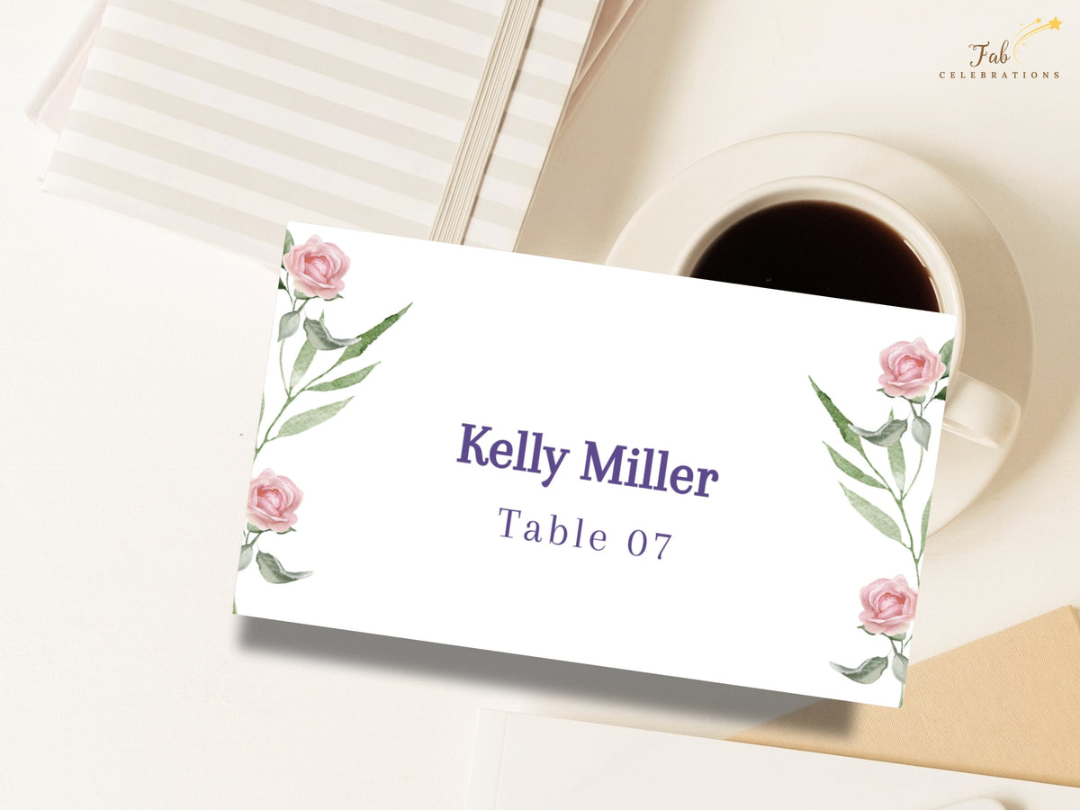 Refined wedding place card featuring watercolor-inspired blush roses and graceful green foliage, with elegant purple typography for the guest name and coordinated table assignment.