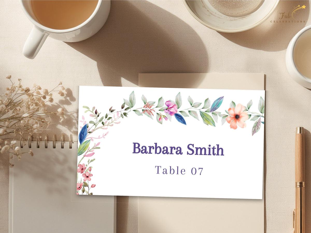 Floral wedding name card featuring watercolor-inspired blossoms and greenery with editable guest name and table number for personalized reception seating.