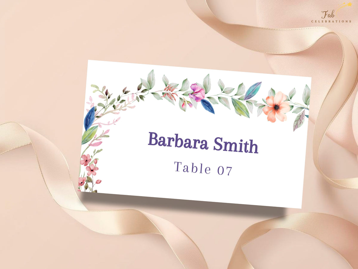Wedding name card template featuring watercolor-inspired floral details with an editable guest name and table number for coordinated reception place settings.