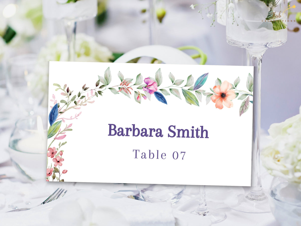 Wedding seating place card decorated with watercolor-inspired flowers and greenery, featuring an editable guest name and personalized table assignment.