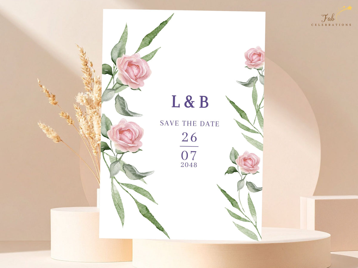 Wedding save the date card featuring soft watercolor-inspired pink roses and sweeping green foliage around the couple's initials and vertically arranged date in elegant purple typography.
