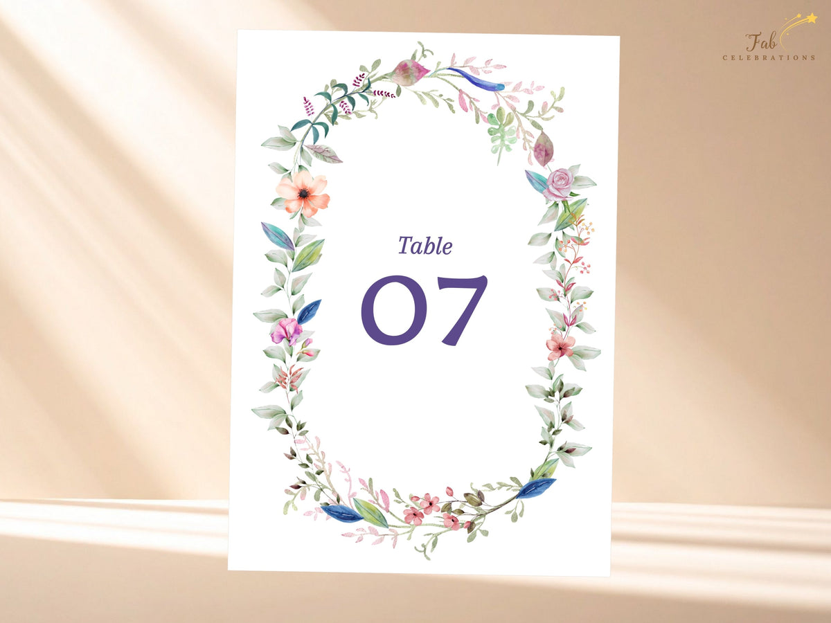 Editable floral wedding table card featuring a watercolor-inspired botanical wreath with delicate blossoms, greenery, and customizable reception numbering.