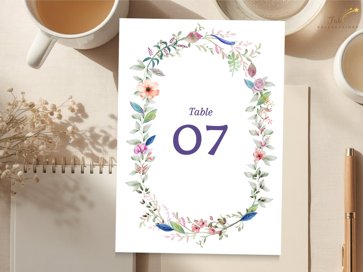 Editable wedding reception table card featuring a delicate watercolor-inspired floral wreath with soft botanical details and customizable table numbering.
