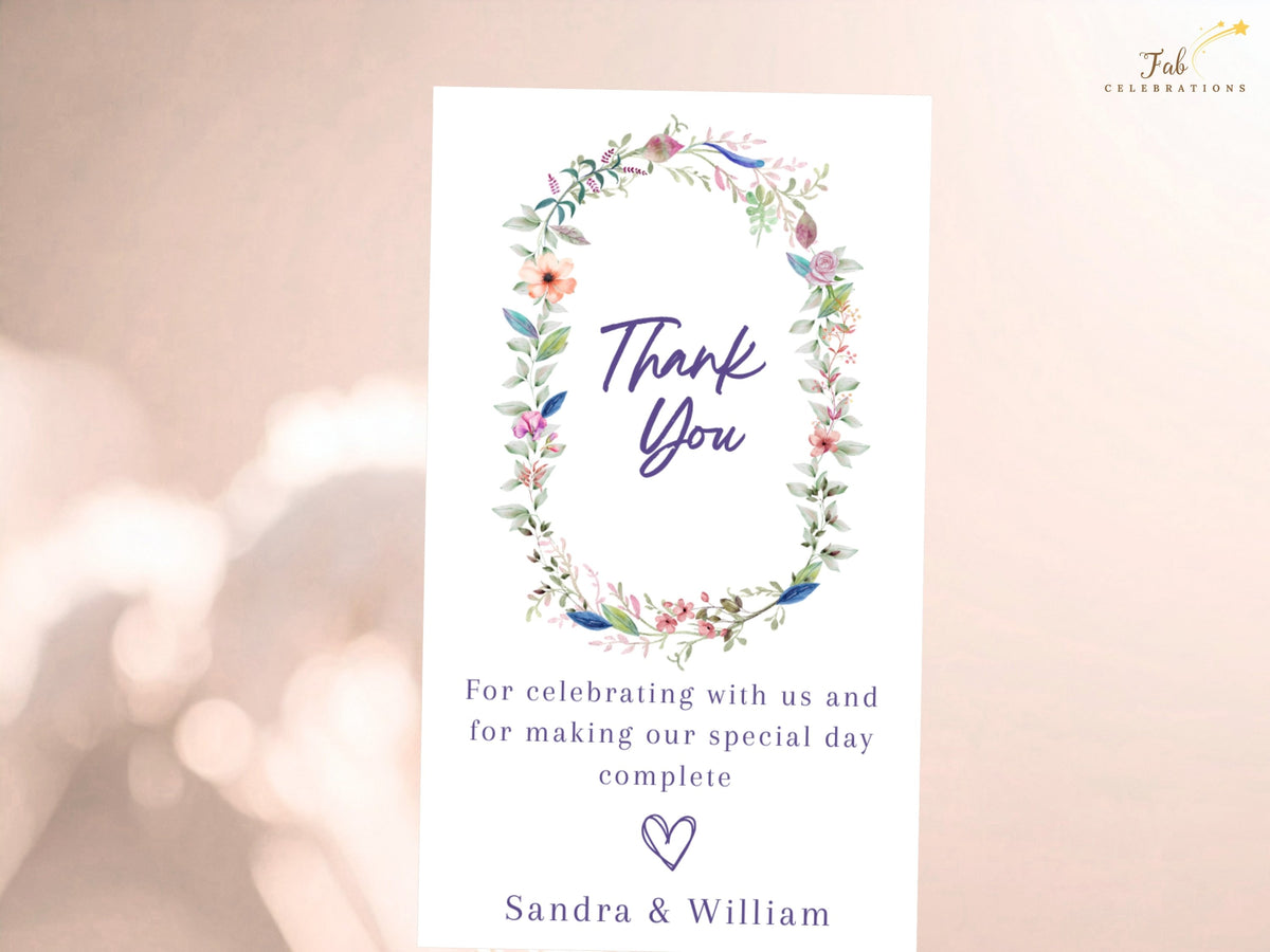 Editable floral wedding thank you card featuring a watercolor-inspired botanical wreath, elegant thank you lettering, customizable message, and personalized names.