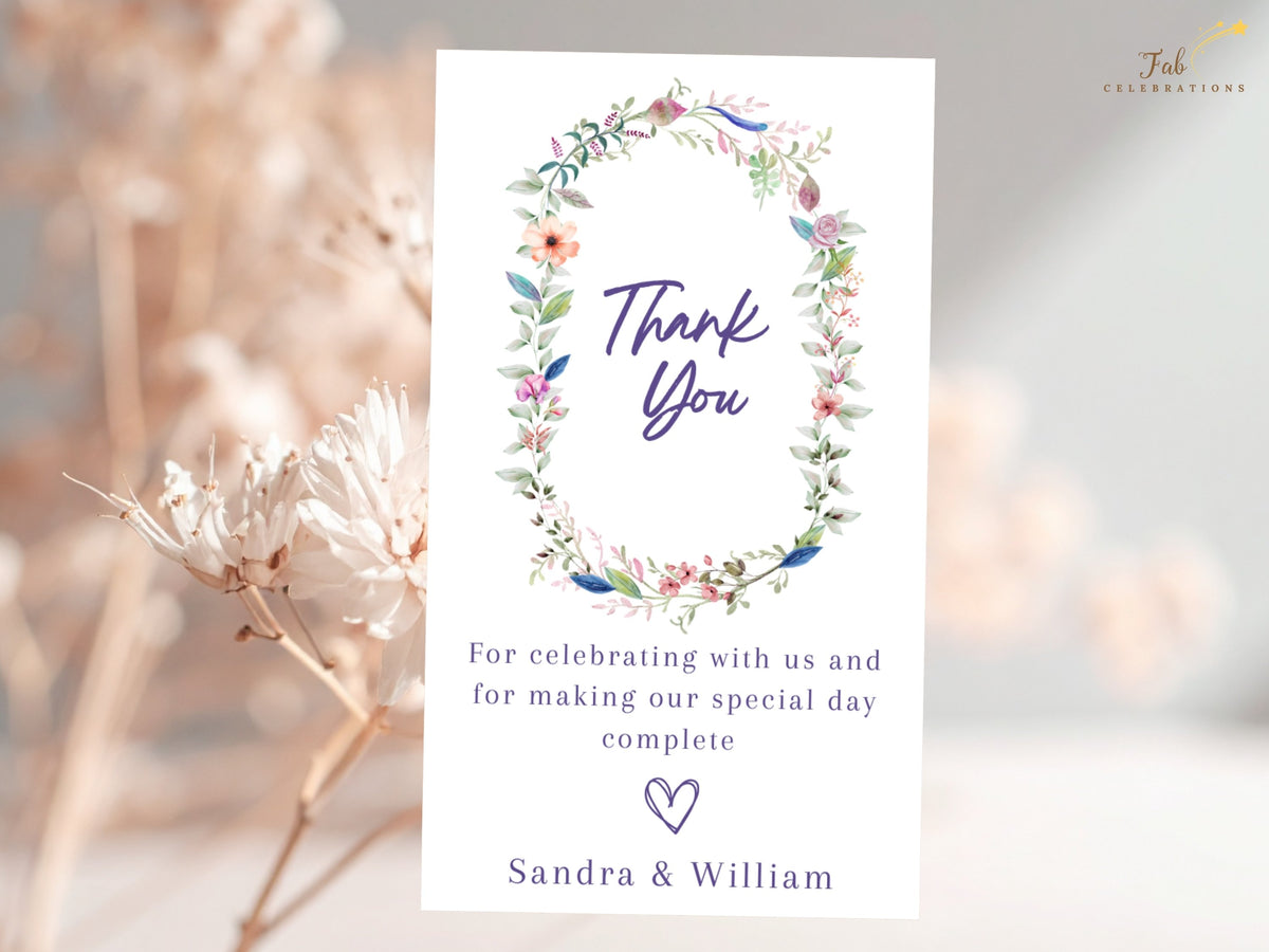 Elegant wedding thank you card decorated with a watercolor-inspired floral wreath, refined thank you lettering, customizable appreciation message, and names.