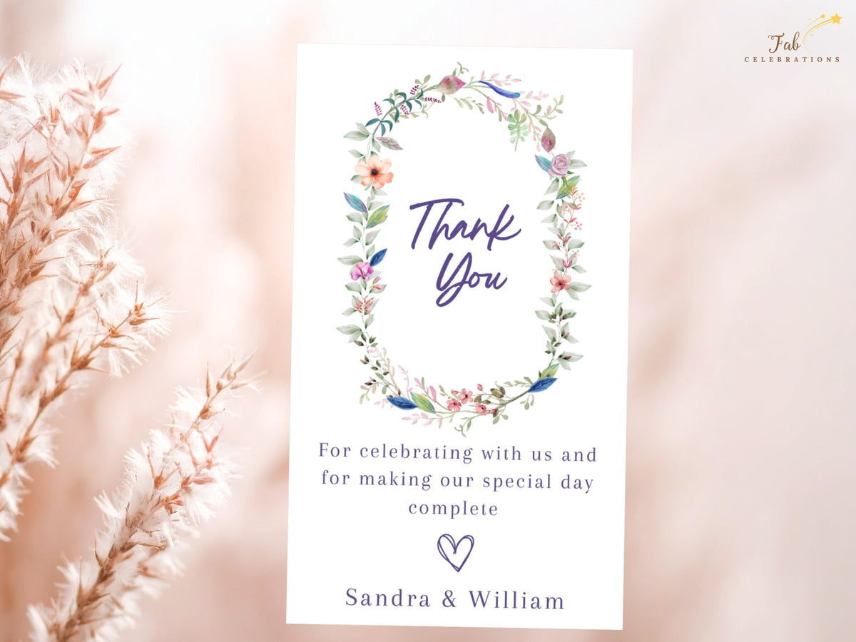 Floral wedding thank you note featuring a colorful watercolor-inspired botanical wreath, elegant thank you lettering, customizable appreciation message, and personalized names.