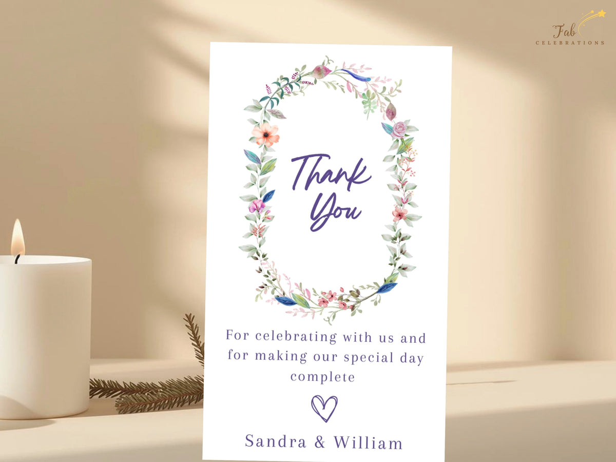 Wedding thank you card featuring a watercolor-inspired floral wreath surrounding elegant thank you lettering, personalized appreciation wording, and couple names.